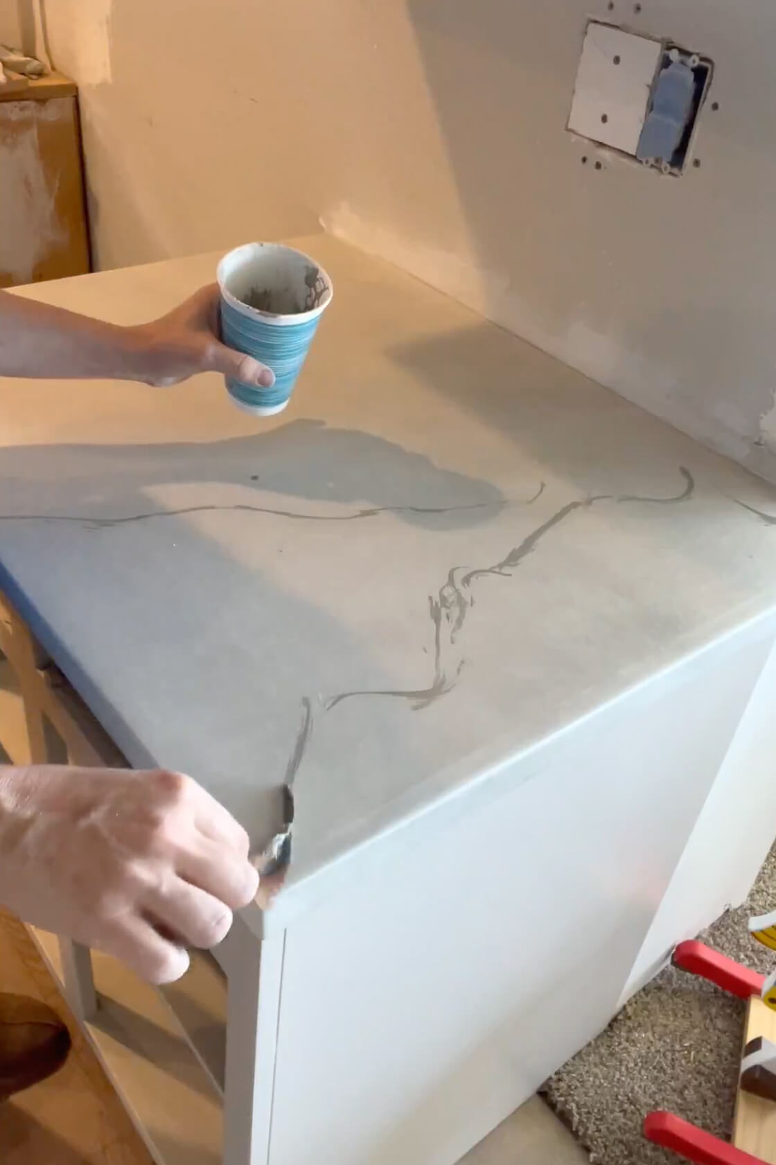 Painting a countertop for a faux marble finish. 